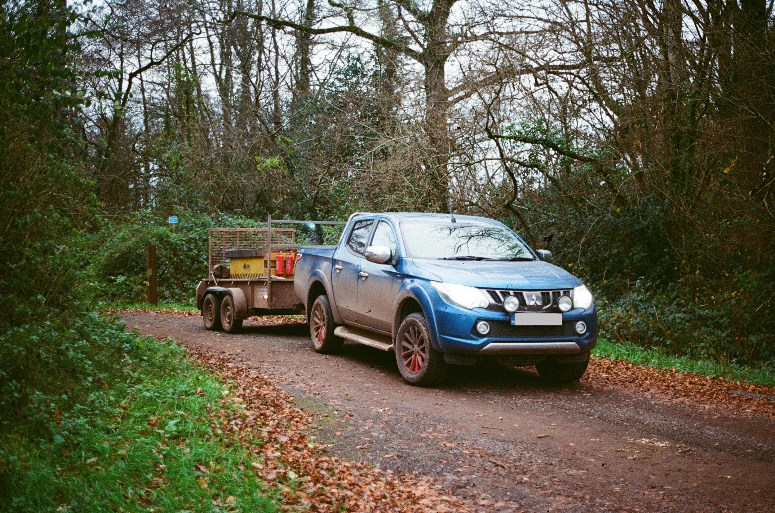 Blue pickup truck with a welding skid as a trailer