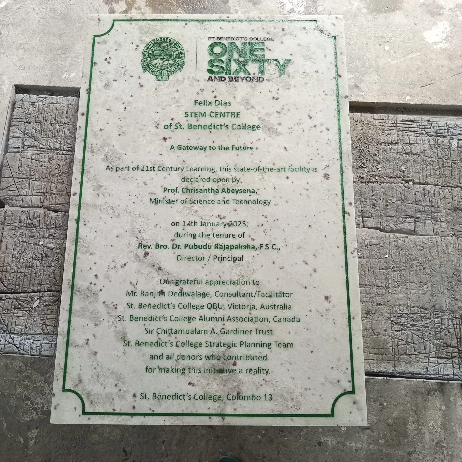 A commemorative plaque at St. Benedict's College Colombo 13 featuring the school emblem and a message honoring Felix Dias for opening a STEM center, signed by Rev. Bro. Dr. Pubudu Rajapaksha, with expressions of gratitude to notable contributors.