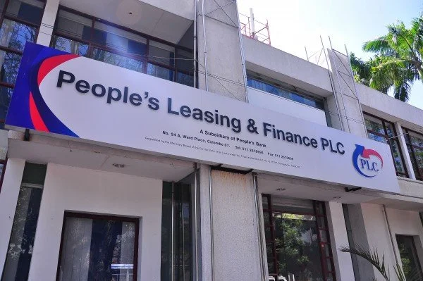 Sign on a building for People's Leasing & Finance PLC with the company's logo.