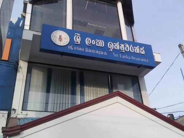 Sri Lanka Insurance office building with blue sign, windows, and red roof accents in the foreground.