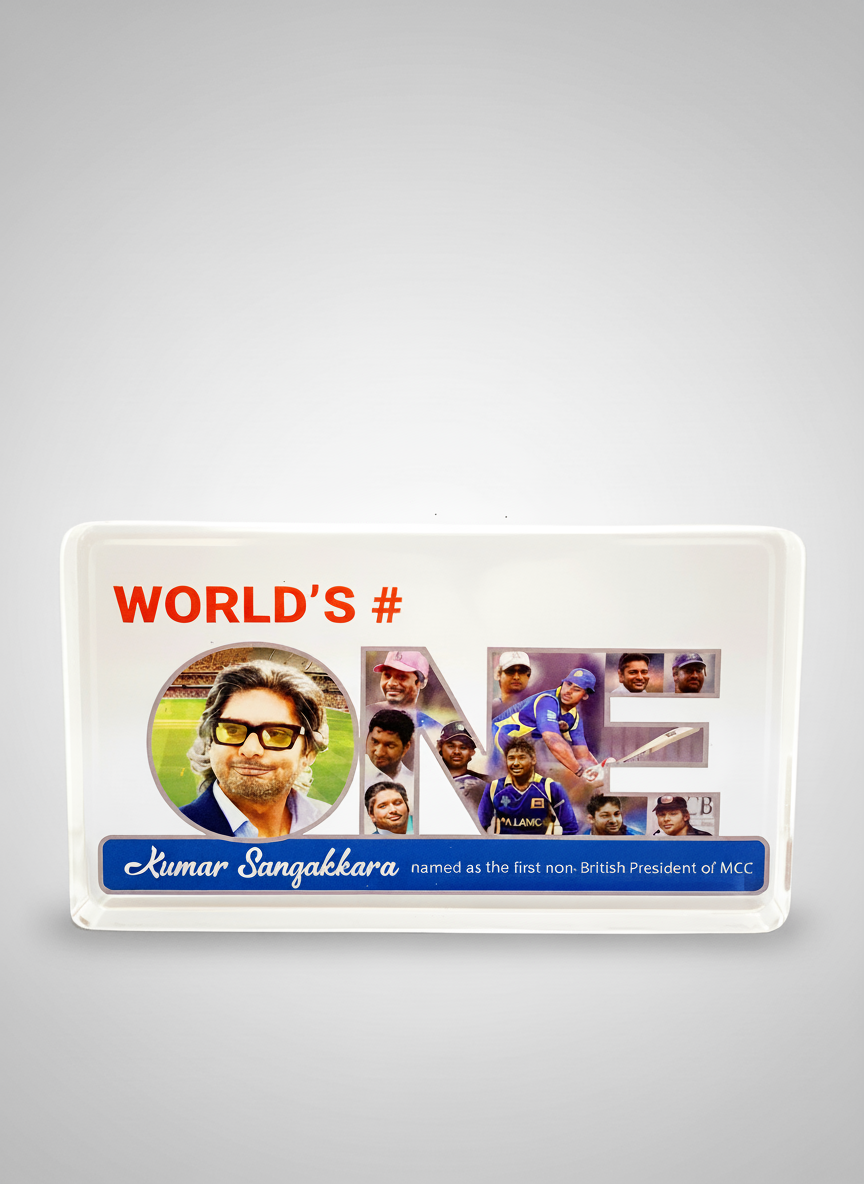 A white tray with a collage celebrating Kumar Sangakkara's cricket achievements, including his photo, the word "ONE" filled with images of his playing career, and the text "WORLD'S #" and "Kumar Sangakkara named as the first non-British President of 