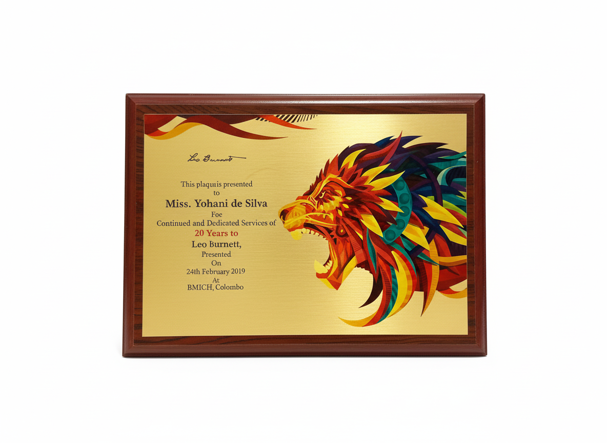 Colorful plaque with a lion's head graphic and text, mounted in a wooden frame.