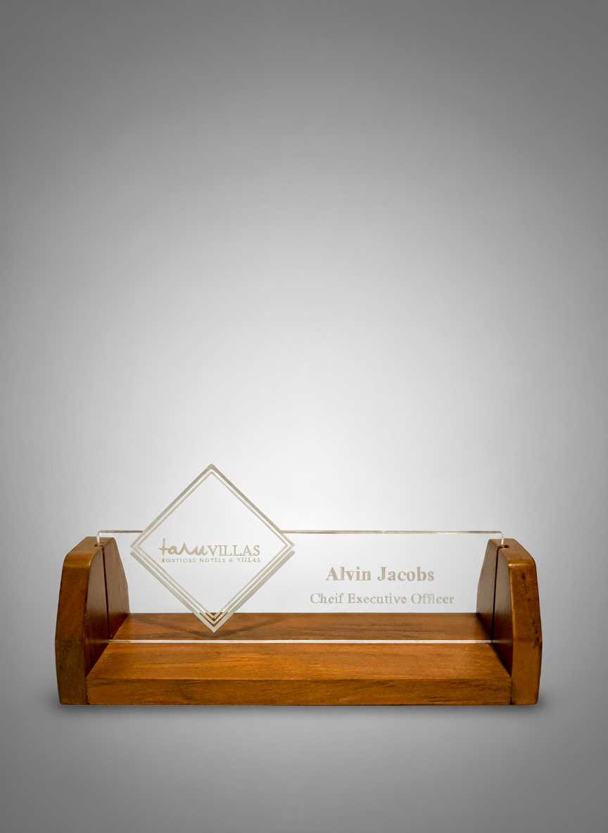 Glass award with wooden base, engraved with 'Tamillas, Aloft Hotel & Villas', and inscribed with the name 'Alvin Jacobs' and title 'Chief Executive Officer'.