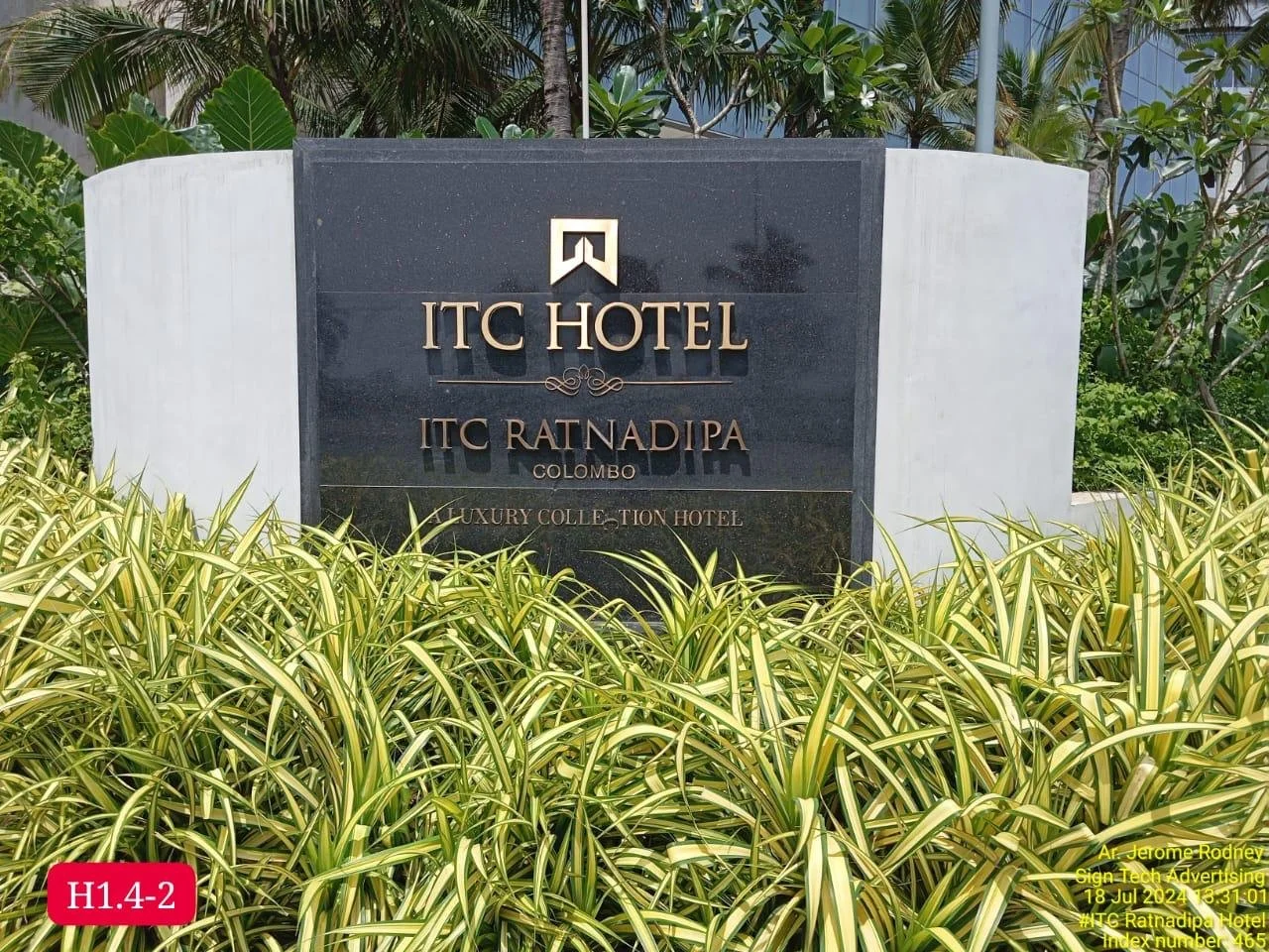 Sign for ITC Hotel in Colombo, Sri Lanka, surrounded by greenery and plants.