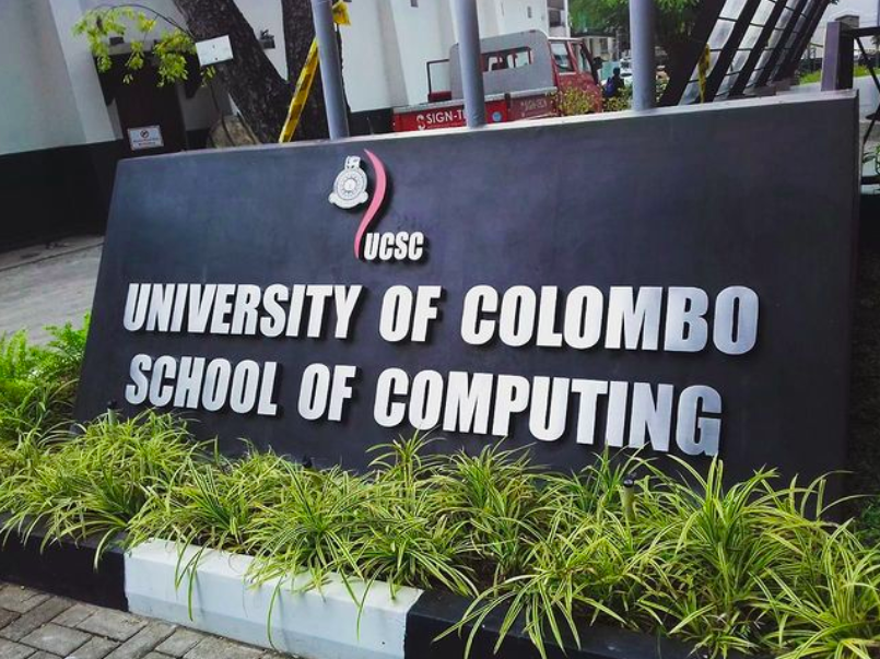 Signboard for University of Colombo School of Computing with greenery in front.