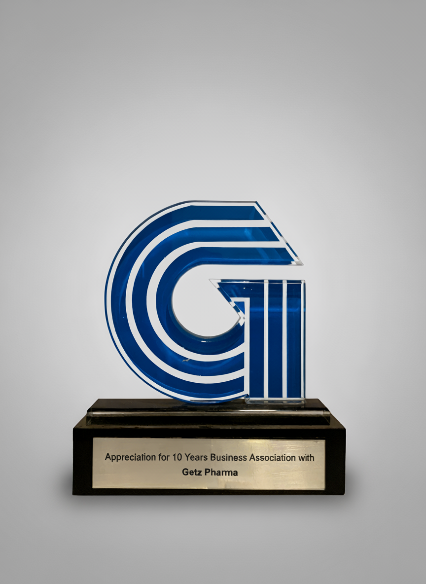 A blue and white neon sign shaped like a stylized letter G, mounted on a black base with a plaque that reads 'Appreciation for 10 Years Business Association with Getz Phama'