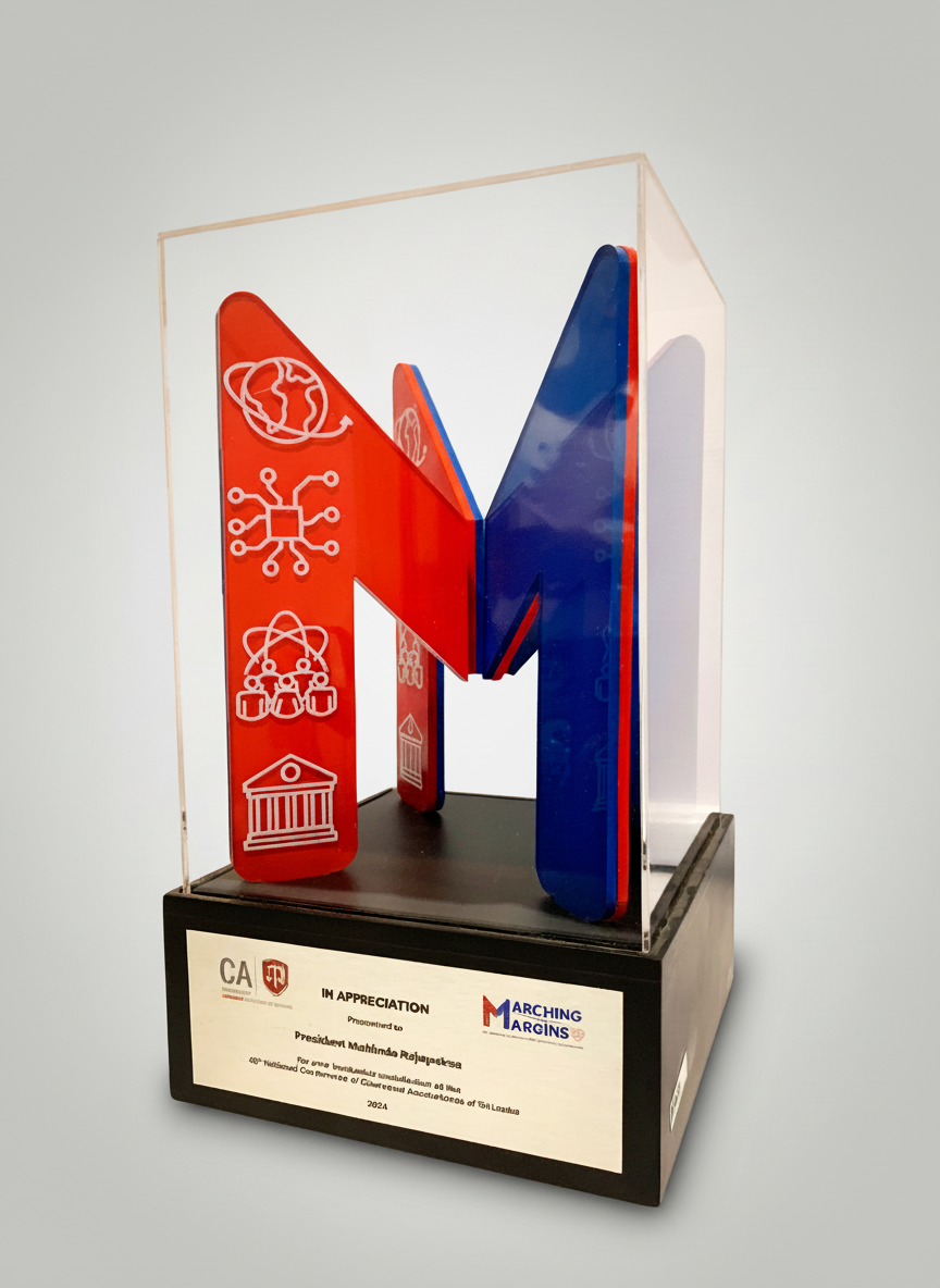 A trophy with a large letter M, featuring icons of a globe, circuit board, team of people, and government building, representing appreciation from Marching Margins to President Mahinda Rajapaksa for his role in national council formation.