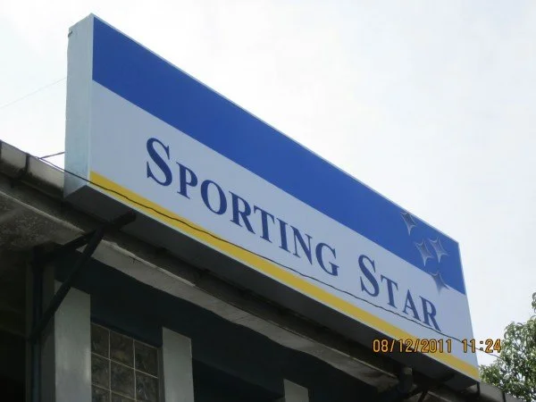 Sign for Sporting Star with blue and white background and star design in the top right corner.