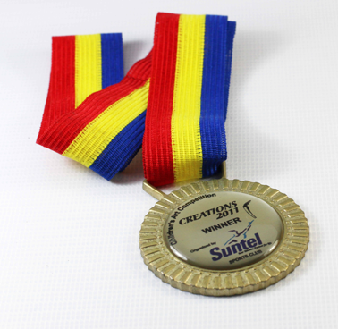 Gold medal with a ribbon in red, yellow, and blue stripes attached, awarded for a 2019 creation contest, labeled as winner by Suntel.