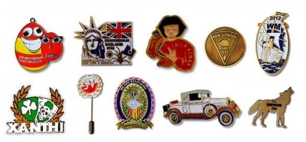A collection of ten various pins and badges featuring cartoon characters, flags, logos, and symbols.