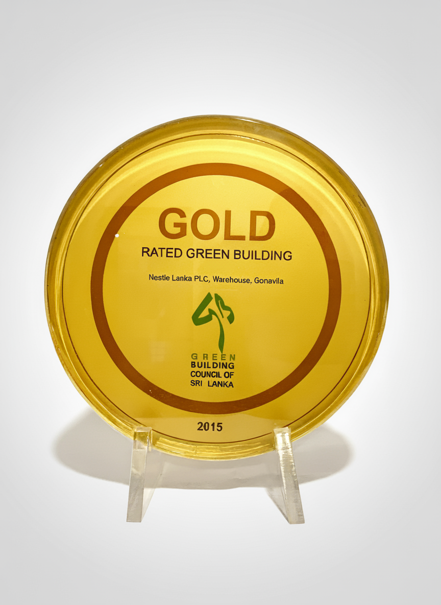 Gold award plate from Green Building Council of Sri Lanka, dated 2015, recognizing Nestle Lanka PLC warehouse in Gonavila as a rated green building.