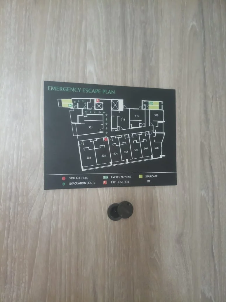 Floor plan for emergency escape, showing rooms numbered 501 through 511, emergency exits, evacuation route, fire hose reel, staircase, and lift, with a red dot indicating the viewer's location.
