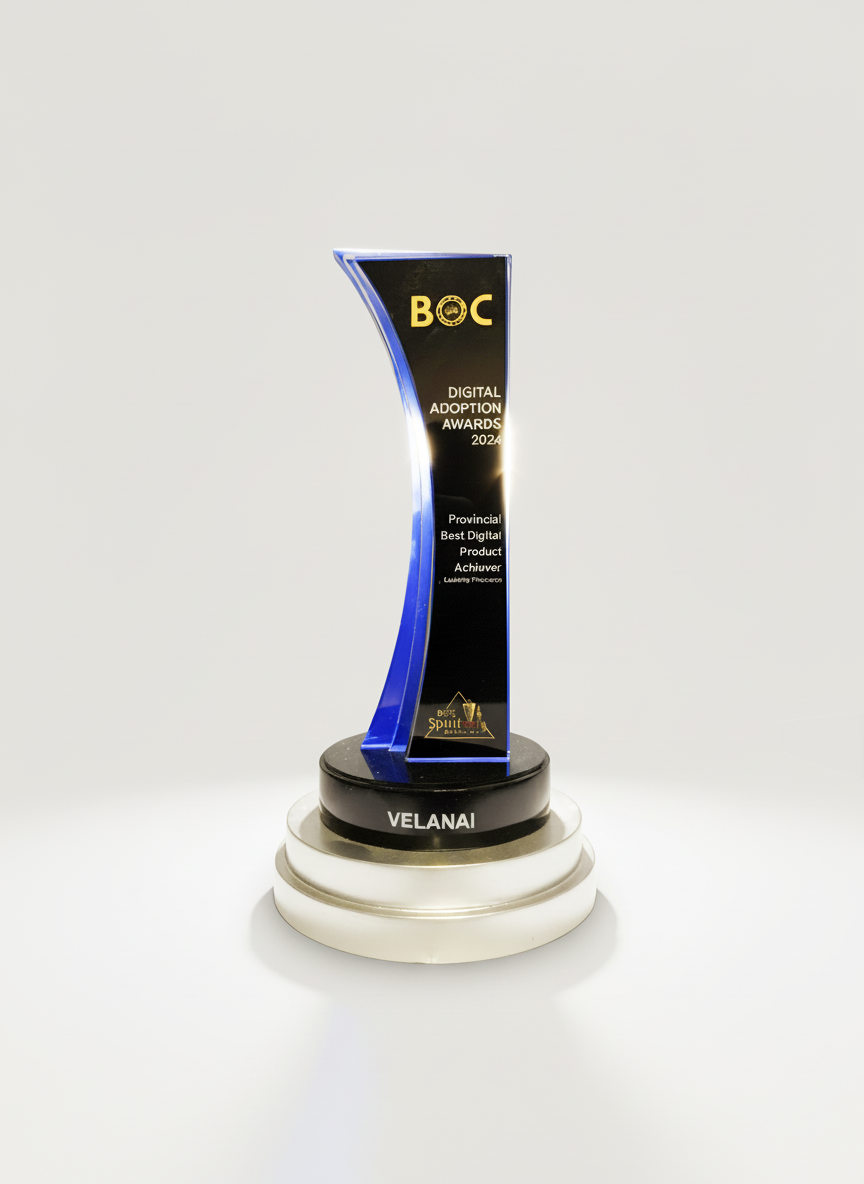 A black and blue award trophy with the words 'BOC Digital Adoption Awards 2024, Provincial Best Digital Product Achiever' and the name 'VELANAI' on a black pedestal, placed on a white circular platform.
