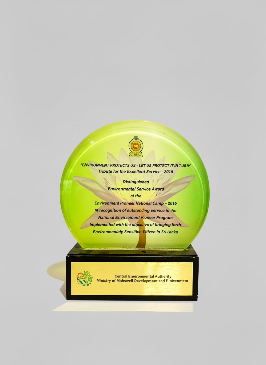 A round, green glass award with a flower design and text recognizing environmental service, mounted on a black base with a label from the Central Environmental Authority of Sri Lanka.