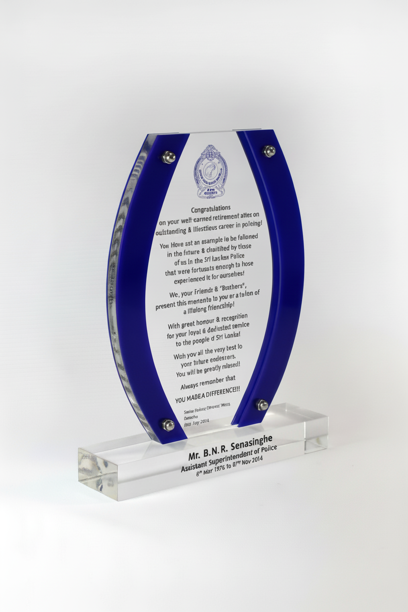 A glass award plaque with a curved shape, blue accents, and an inner silver border. The plaque has text and a logo engraved on it, mounted on a clear rectangular base with engraved text.