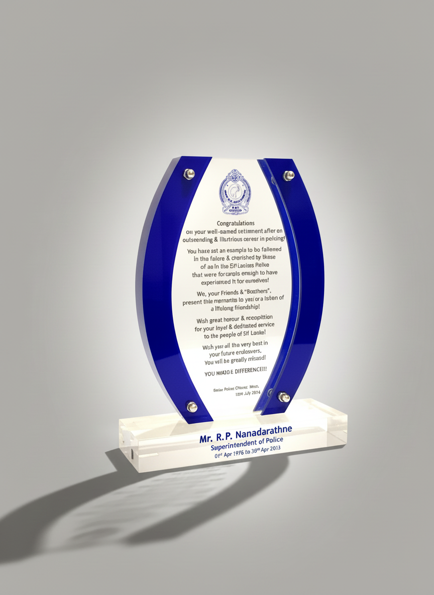 A ceremonial award plaque with a blue and clear design, inscribed with congratulations and commemorating Mr. R. P. Nandaradhne's service as Superintendent of Police from April 1, 1976, to April 30, 2013.