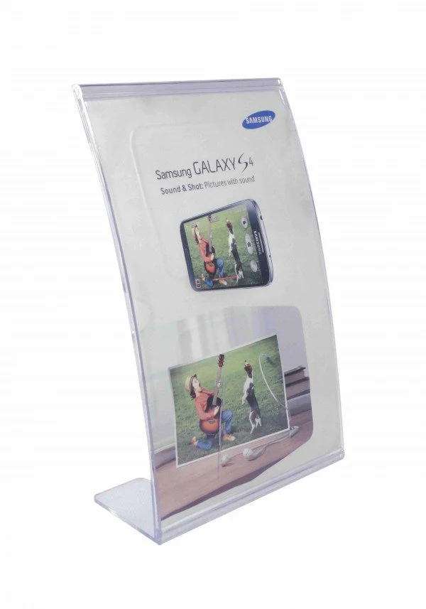A clear plastic display stand featuring a Samsung Galaxy S4 phone advertisement with images of children playing and a person playing guitar.