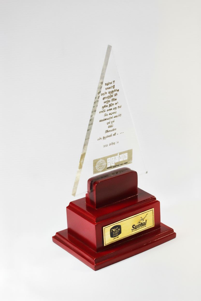 Red trophy with a gold plaque and a clear glass triangular top with text and logo, set against a white background.