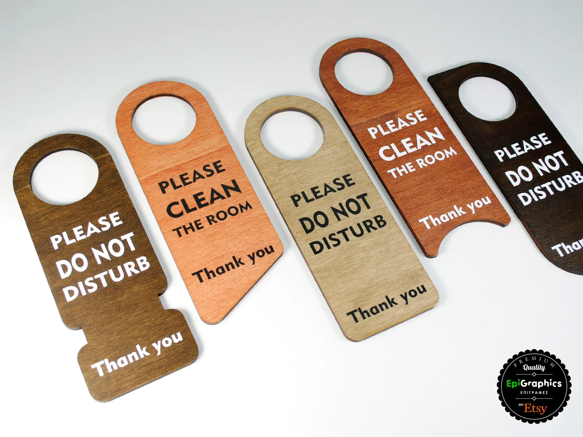 Set of five wooden door hangers with messages, in colors brown, orange, beige, red, and dark brown, reading 'Please Do Not Disturb' or 'Please Clean the Room', on a white background.