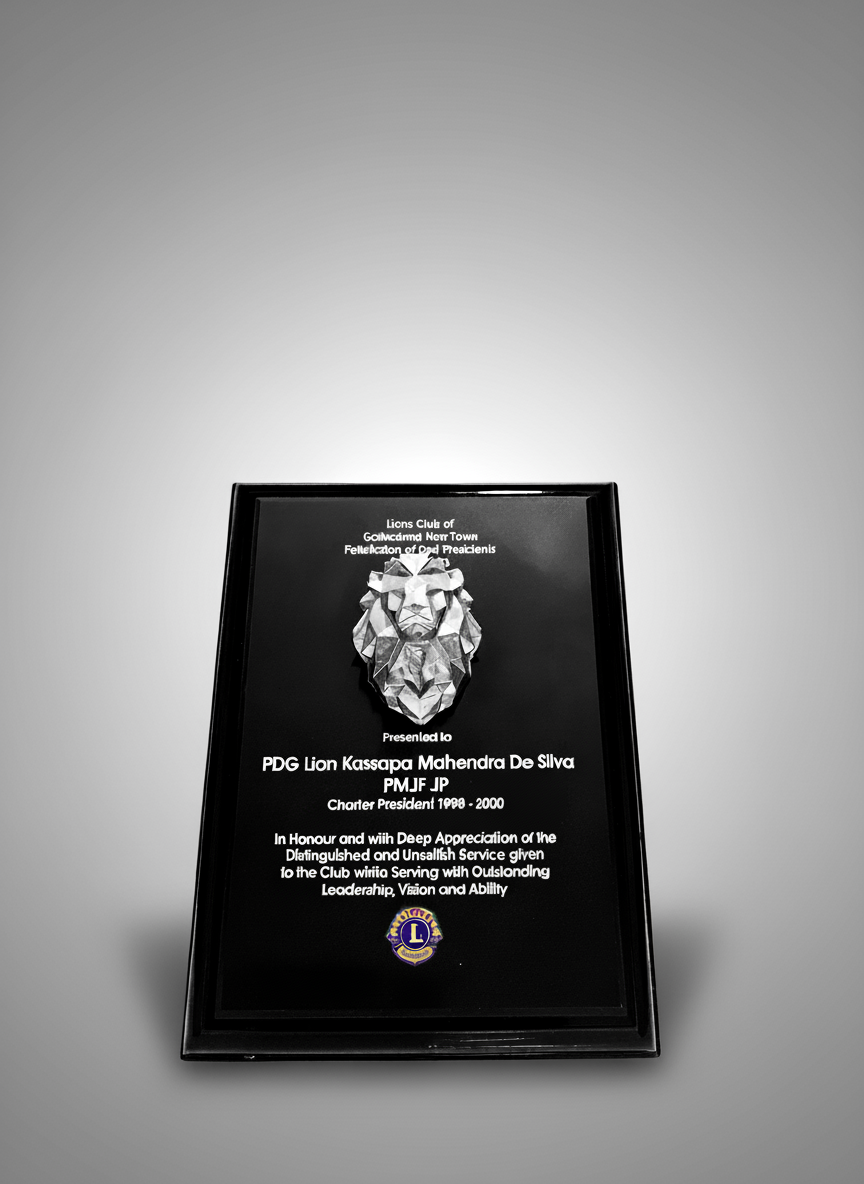 Plaque with a lion's head emblem and text recognizing PDG Lion Kassapa Mahendra De Silva for outstanding service, presented by the Lions Club of Galle/Matara, Sri Lanka.