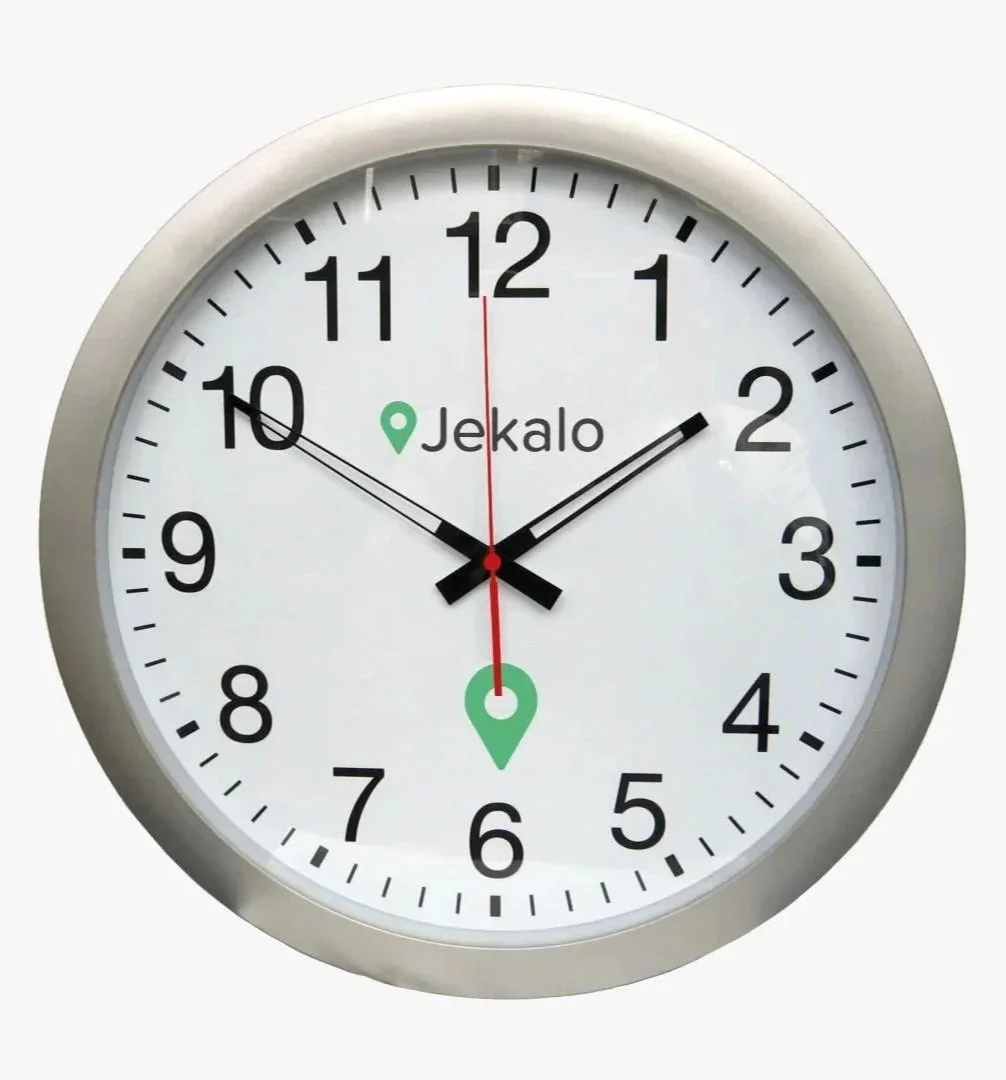 An analog wall clock showing the time as 1:52:30 with the brand name 'Jekalo' and two location icons.