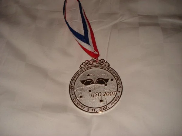 Medal for the 44th Missouri International Junior Science Olympiad, held in December 2007, with a ribbon in red, white, and blue.