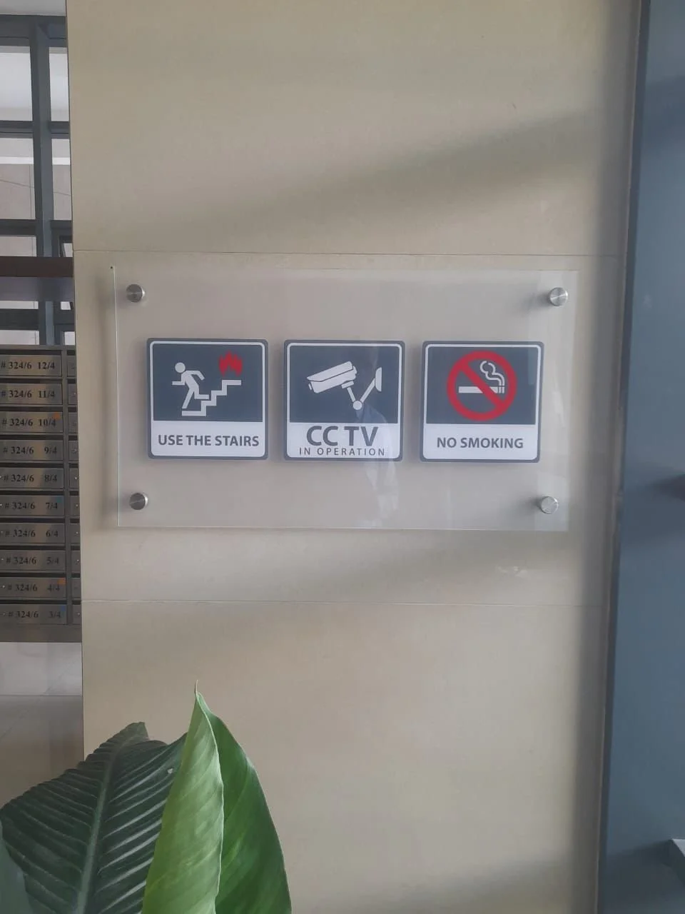 Sign with instructions: use the stairs, CCTV in operation, no smoking.