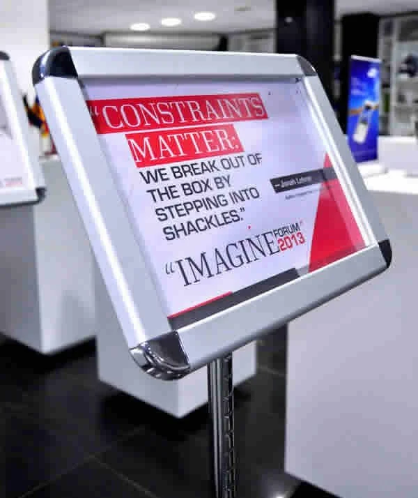 Sign with a motivational quote about breaking out of constraints and imagining new possibilities.