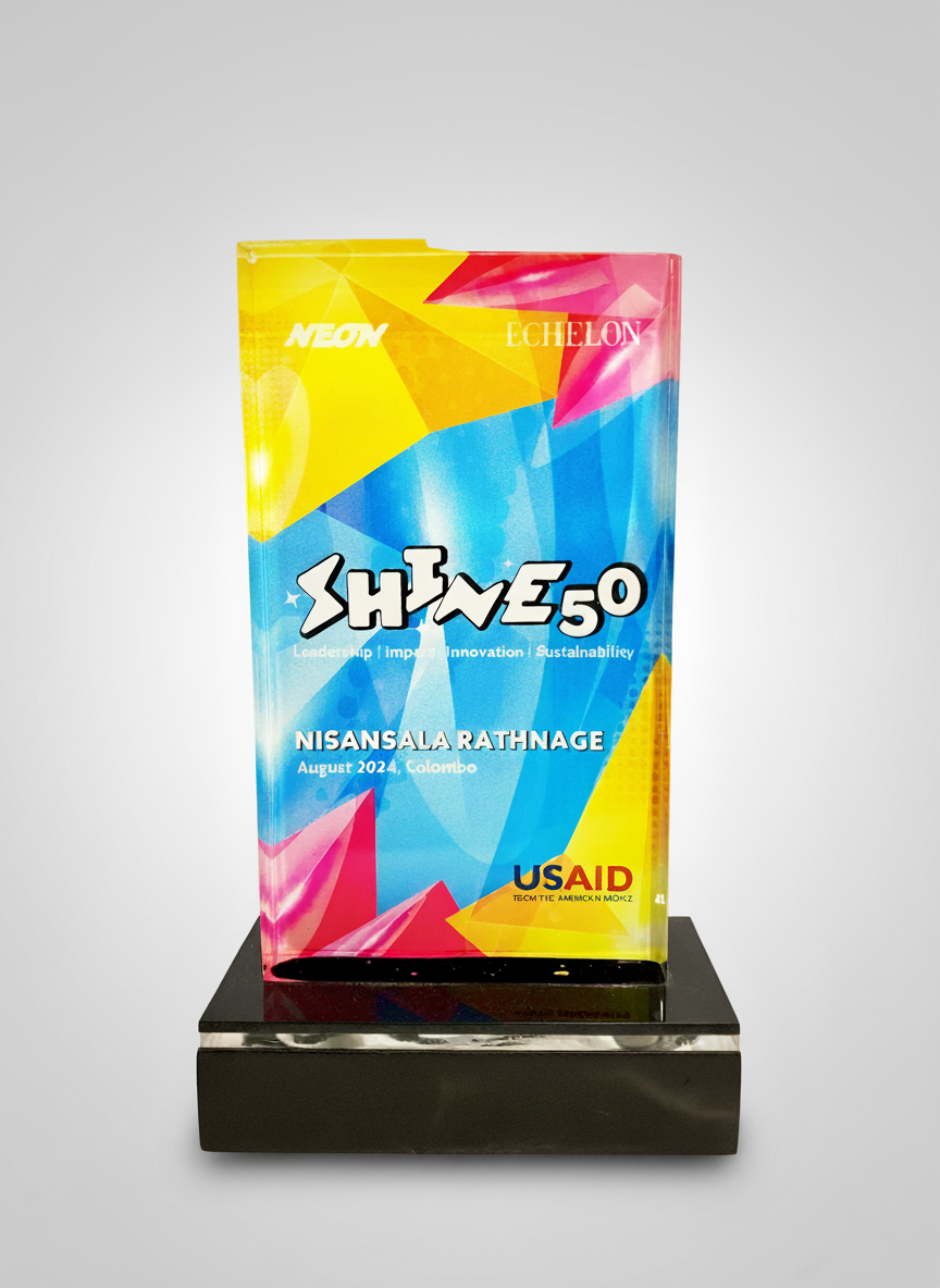Colorful event plaque displaying the event name "SHINES 5.0" with the subtitle "Leadership | Impact | Innovation | Sustainability." The event features Nisansala Rathnage, held in August 2024 in Colombo. The plaque also shows the organizations NEON, E