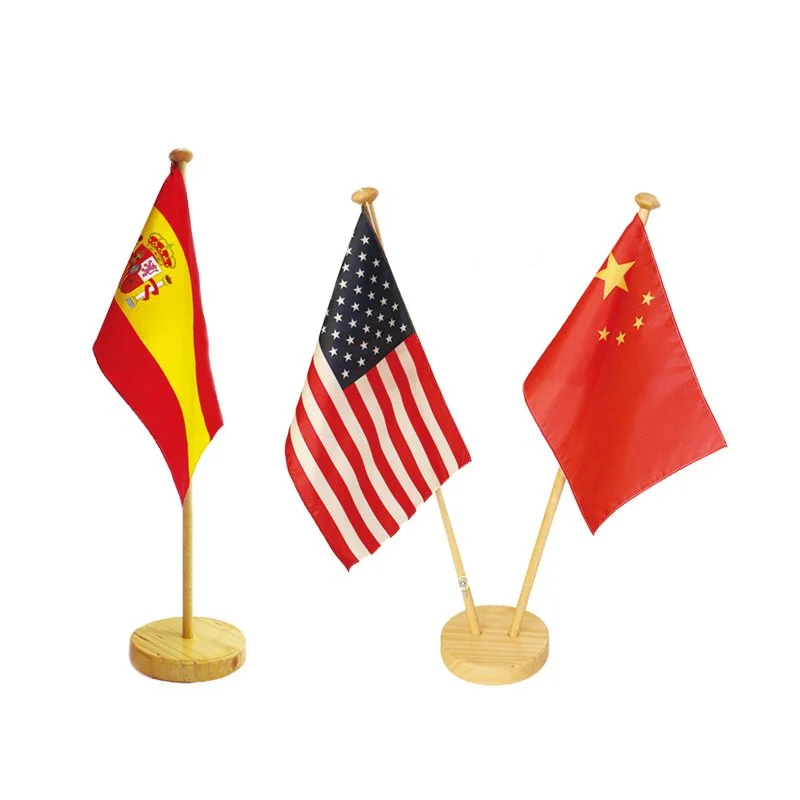 Three small flags on wooden stands, from left to right: Spain, United States, and China, on a white background.