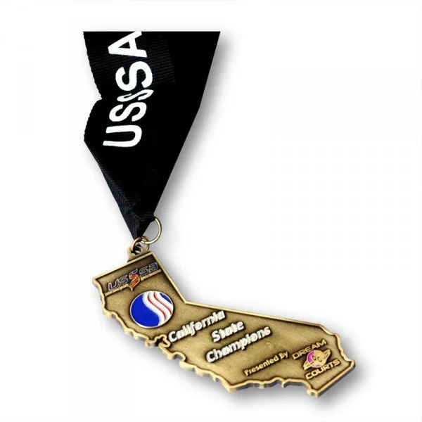 Gold-colored medal shaped like the state of California with a black ribbon labeled 'USA', featuring the California state flag, and text that reads 'California State Champions, presented by Dream Fields'.