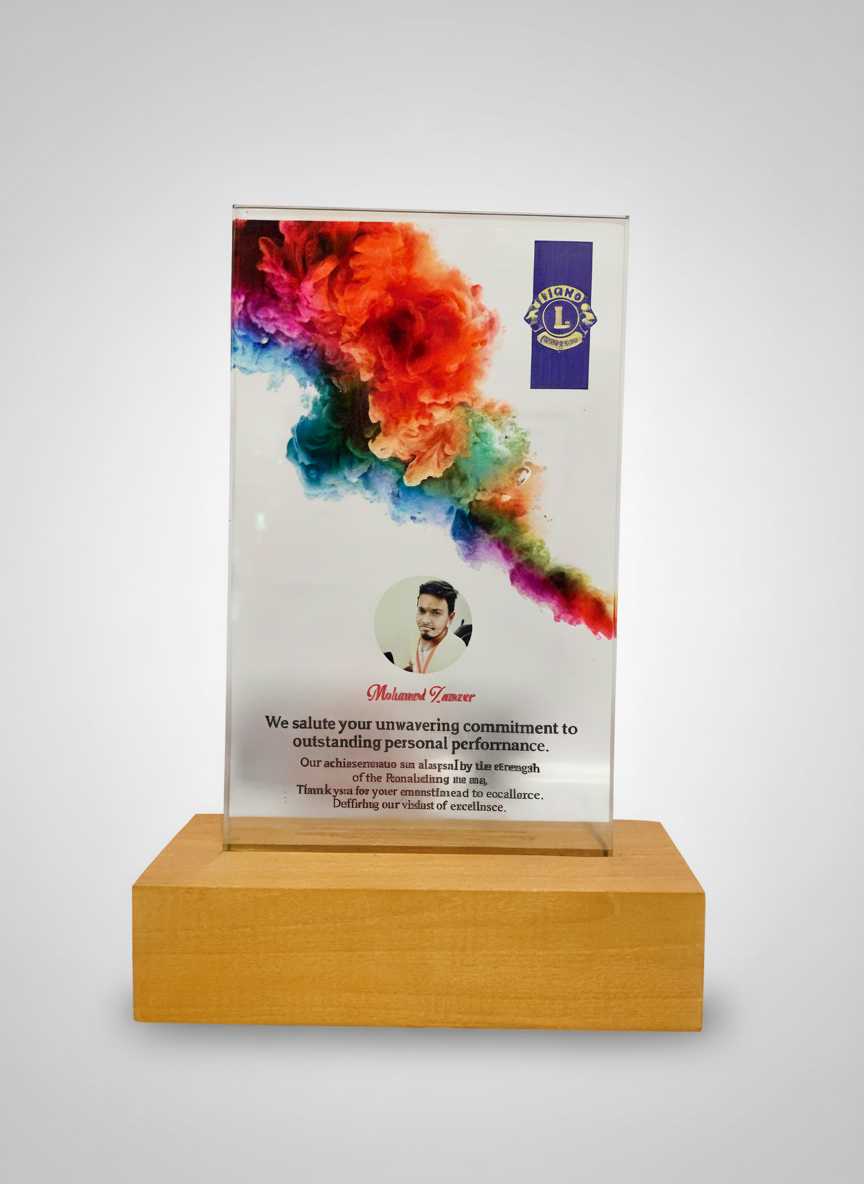 A glass award featuring a colorful ink cloud, a person’s photo, and a message of appreciation on a wooden base.