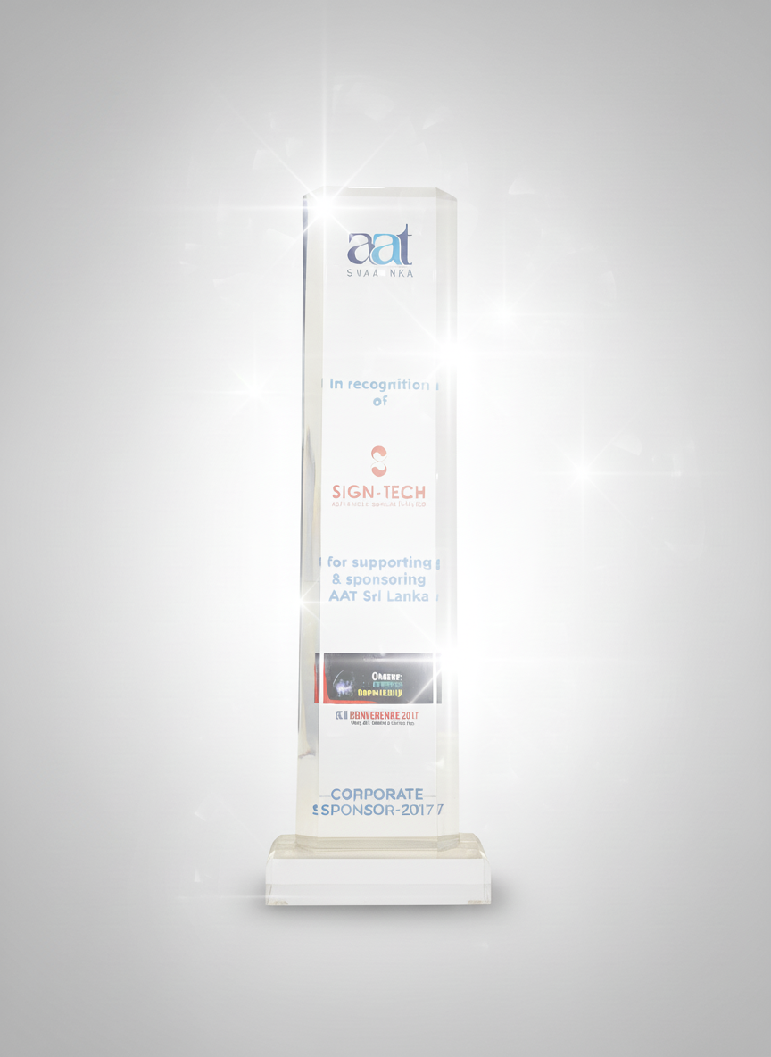 A tall, transparent, rectangular award with an illuminated top, inscribed with the logos of AAT and Sign-Tech, and text recognizing sponsorship support for an event in Sri Lanka in 2017.