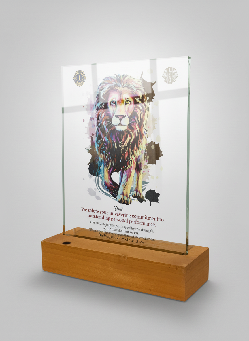 Colorful lion illustration on a glass plaque with wooden base, with text about dedication and excellence.