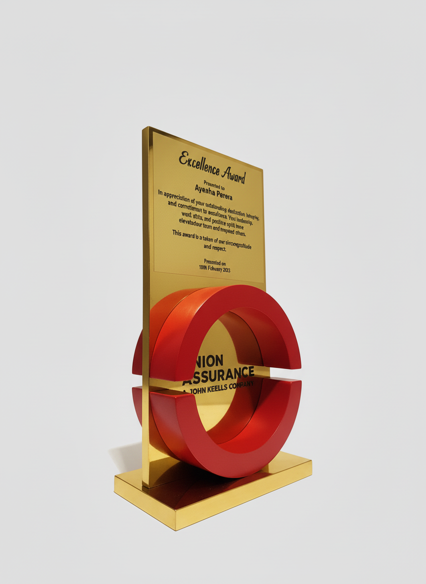 A gold award plaque with a red circular design element. The plaque features text about an excellence award presented to Ayeaha Perera, with a date of February 10, 2023, and is associated with Union Assurance, a John Keells Company.