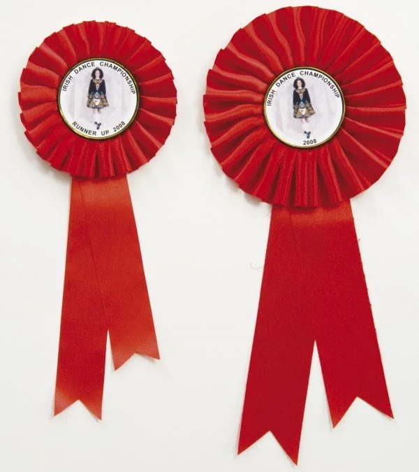 Two red ribbons with circular rosettes featuring a dancer in traditional Irish attire, labeled 'Irish Dance Championship Runner Up 2008'.