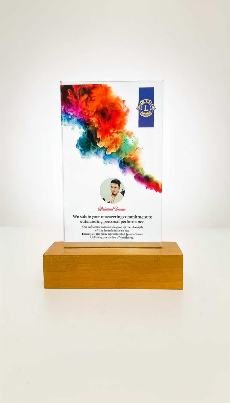 A clear acrylic award with a colorful smoke design, on a wooden base, featuring a photo of a man, a Lions Club logo, and a message of appreciation.