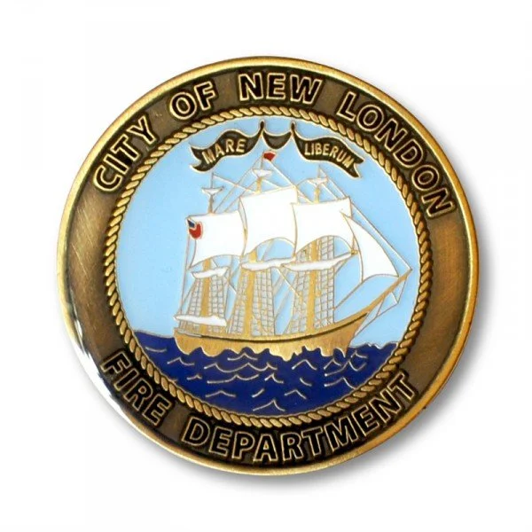 Seal of the City of New London Fire Department featuring a sailing ship with a blue background, surrounded by a gold border with text.