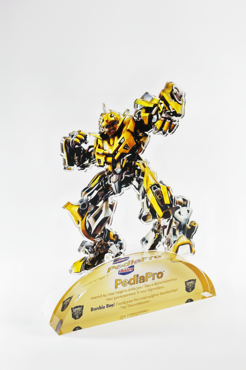 A cardboard cutout of a yellow robot standing on a yellow base with the text "PedlaPro" and various logos, against a plain white background.