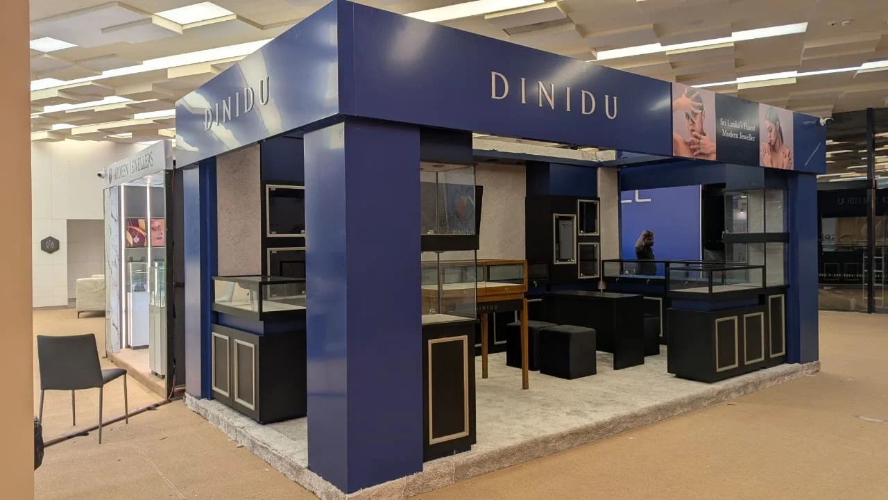 A jewelry booth called DINDU featuring displays for jewelry and accessories, located in an indoor shopping mall.