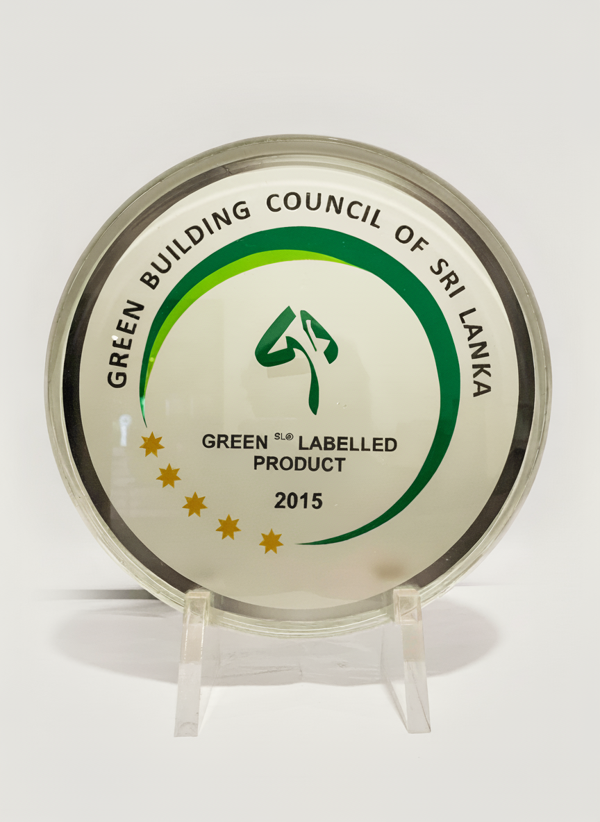 A circular plaque awarded by the Green Building Council of Sri Lanka in 2015 for a green labeled product, with a green logo and five gold stars on a white background.