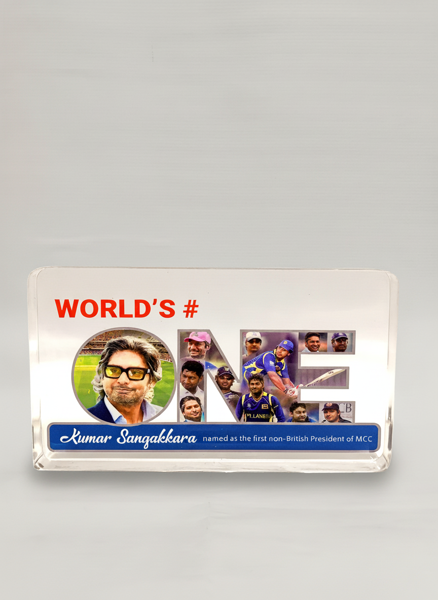 A sign that reads 'World's # One' with photos of Kumar Sangakkara and other cricket players, along with a blue banner stating 'Kumar Sangakkara named as the first non-British President of MCC'.