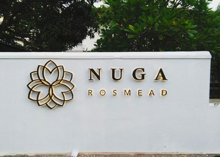 Sign for Nuga Rosmead with a floral logo and greenery in the background.