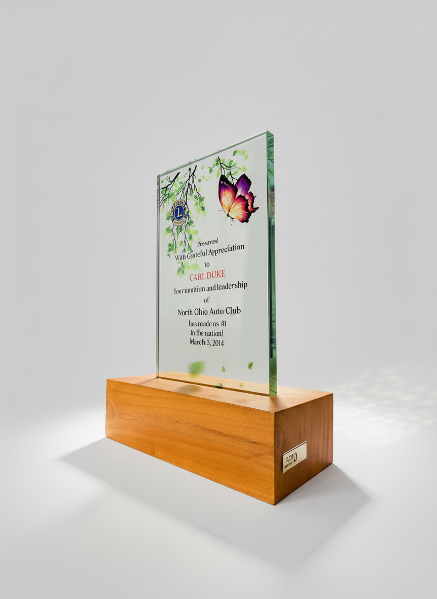 Glass award with butterfly and leaves design on a wooden base, inscribed with a certificate of appreciation for Carl Duke from the North Ohio Auto Club, dated March 3, 2014.