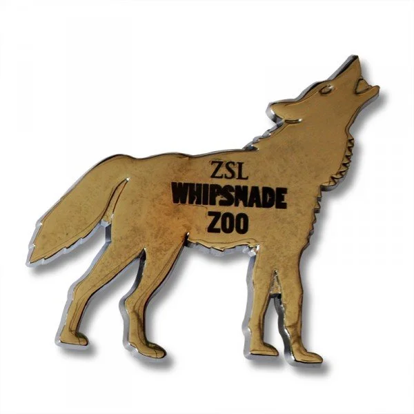 A metal cutout of a howling wolf with the words "ZSL WHIPSNADE ZOO" printed on it.