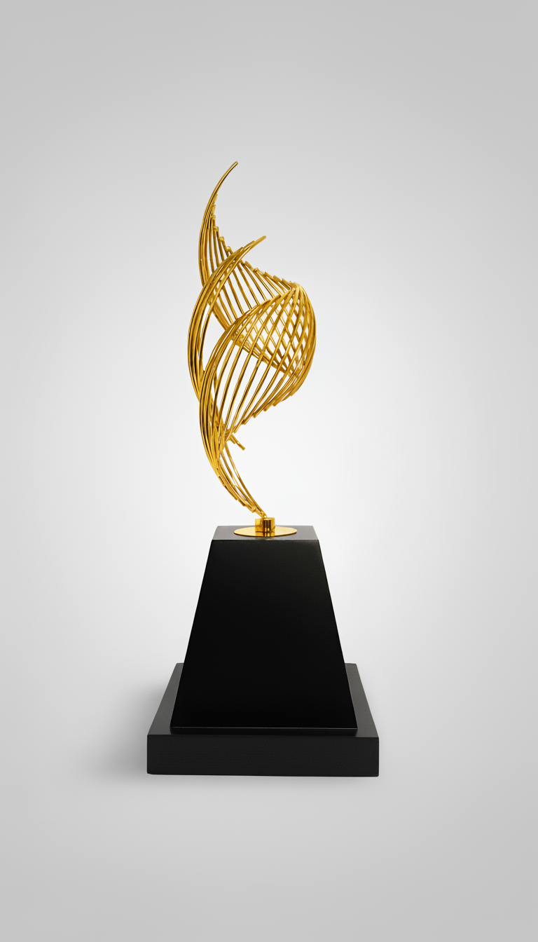 A modern gold sculpture with an abstract, twisting design mounted on a black pedestal against a plain white background.