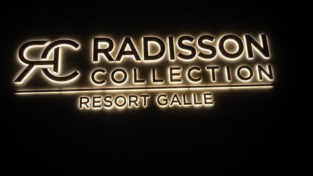 Illuminated sign for Radisson Collection Resort Galle featuring the logo and hotel name.