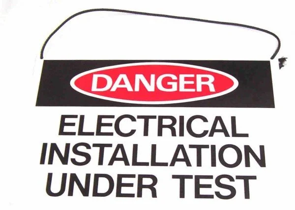 Warning sign indicating electrical installation is under test.