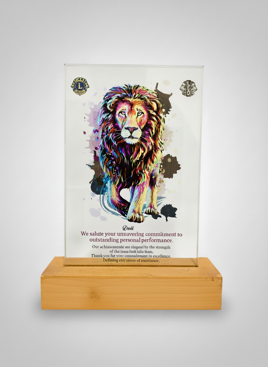 Colorful illustrated lion on a glass plaque with logos at the top and text at the bottom, mounted on a wooden base.