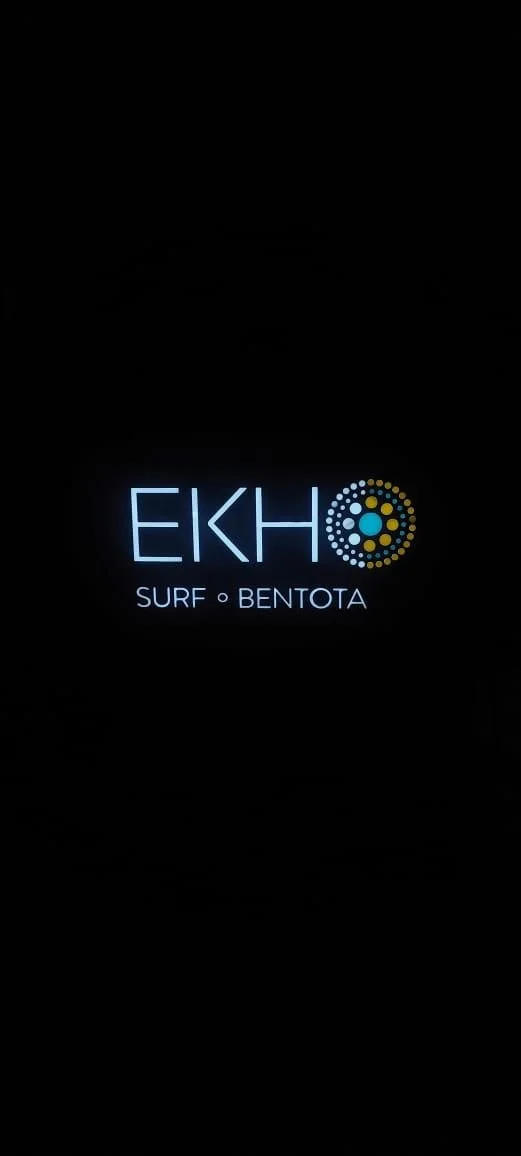 Neon sign displaying the text "EKHO" with a circular logo next to it, and underneath, the words "SURF" and "BENTOTA" separated by a dot.